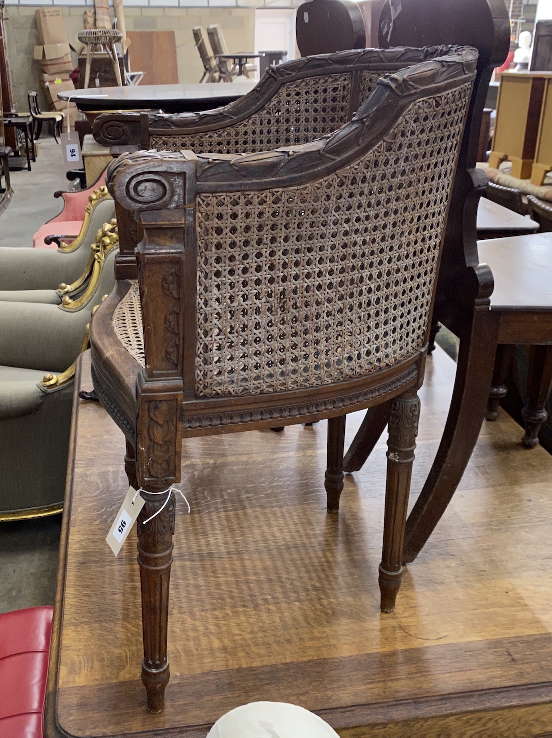 A Louis XVI style caned walnut Bergere chair, width 57cm, depth 44cm, height 79cm